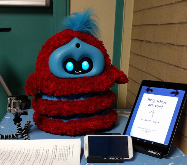 a red and blue robot sits on a table