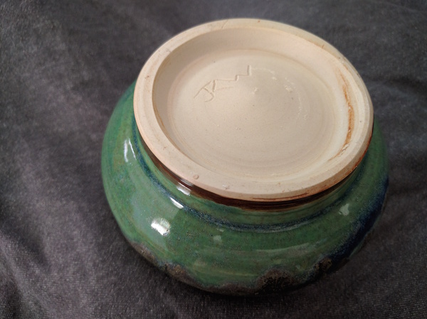 bottom of a white clay bowl, showing my initials