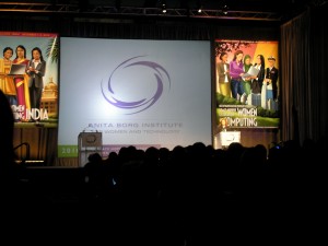 _view of the stage, with GHC posters and the Anita Borg institute logo, from the dark audience_