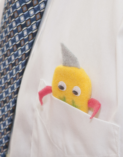 felt monster with googly eyes peeking out of a shirt pocket